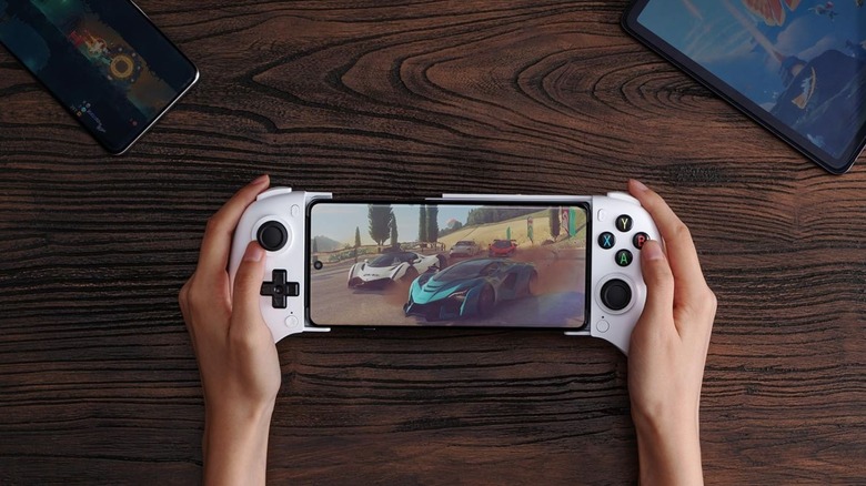 8BitDo Mobile Gaming Controller with phone installed and racing game displayed.