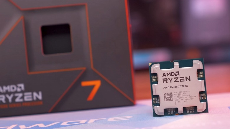 AMD Ryzen 7 7700X CPU with box in background