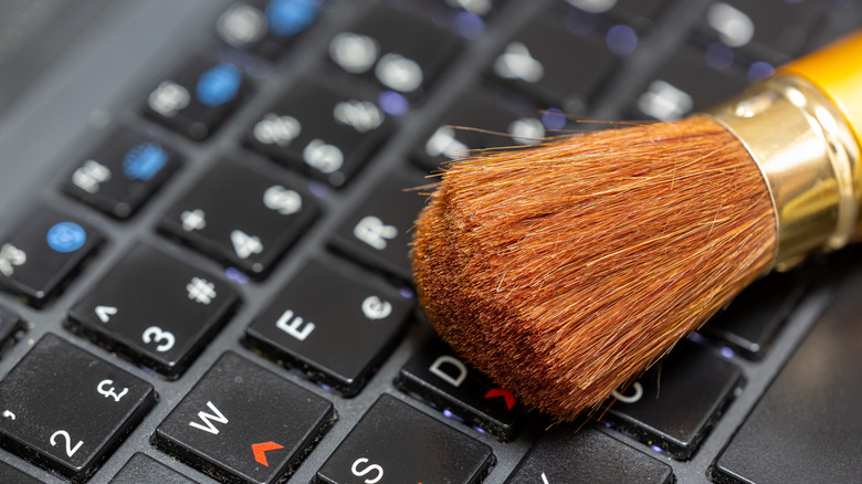 Makeup brush resting on a computer keyboard.