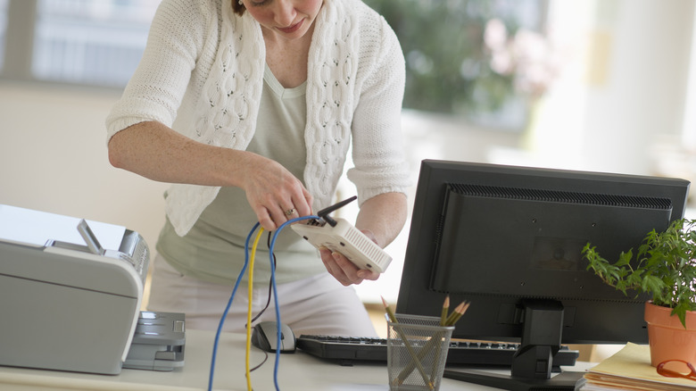 Woman fixing the internet router