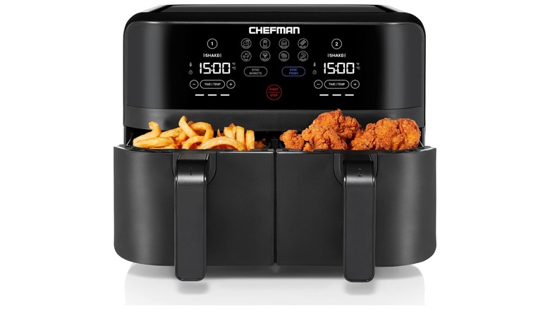 Black electronic air fryer with two baskets filled with fried food