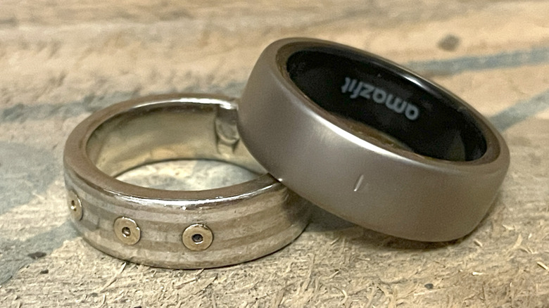 Helio Ring next to a bulky metal wedding ring.