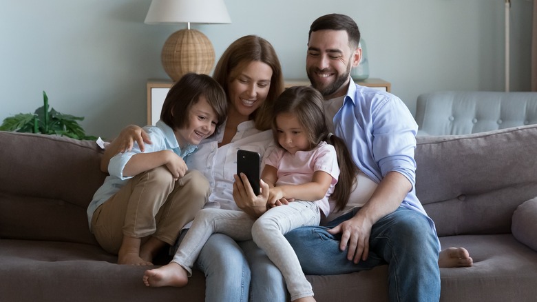 Parents and children using phone