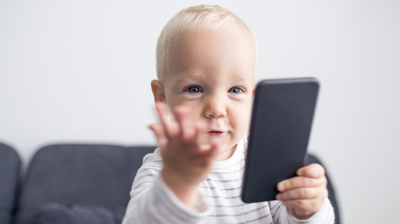 Baby holding a phone 