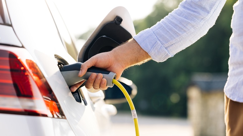 EV owner plugging in charger