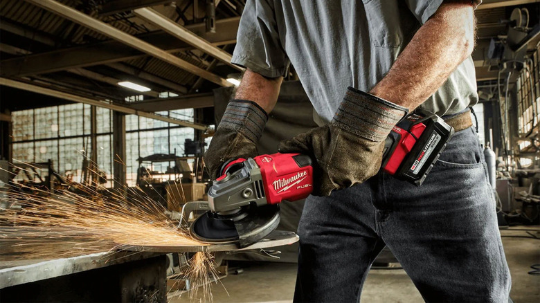 man using a Milwaukee grinder 