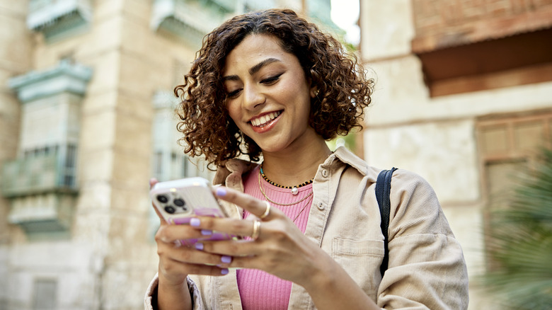 A woman holding an iPhone