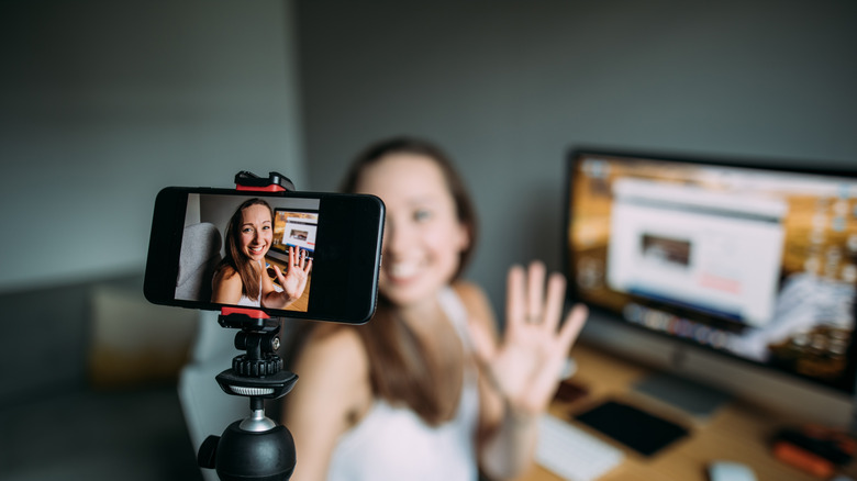 Woman gesturing into an iPhone