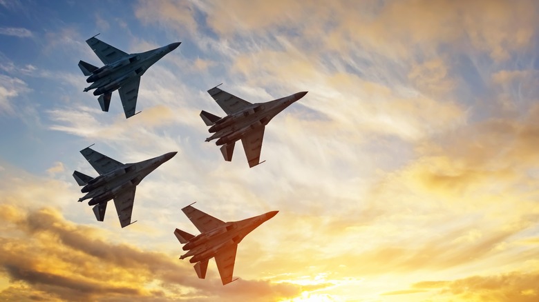 Four fighter jets flying in formation.