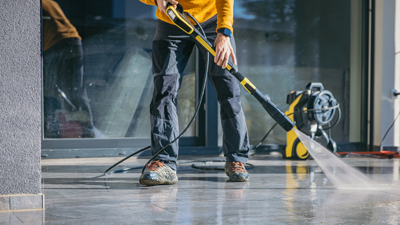 person using pressure washer