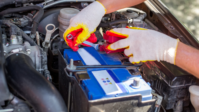 Mechanic installing a new car battery