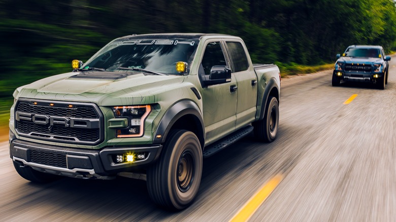 A gray Ford F-150 Raptor in the snow.