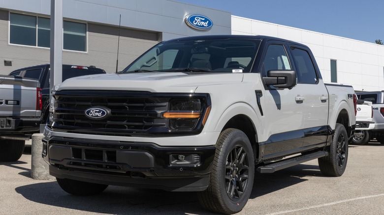 Grey Ford pickup truck parked in a Ford dealership lot