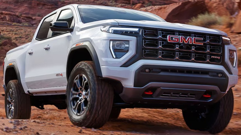 White 2024 GMC Canyon AT4 truck on red rocks