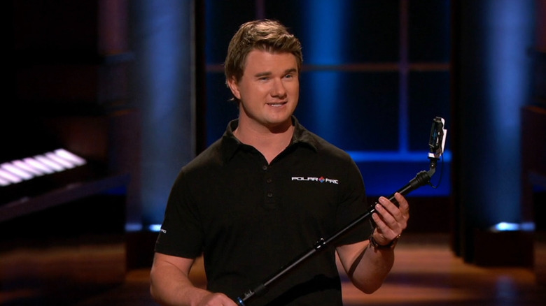 Jeff Overall holding a selfie stick on Shark Tank