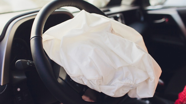 Deployed airbug in a car steering wheel