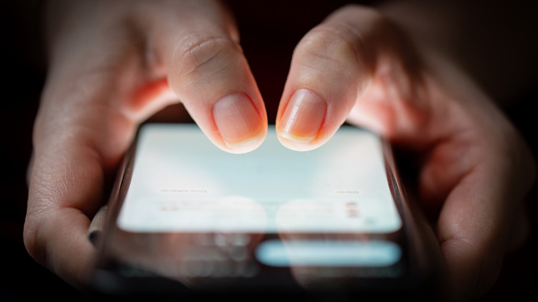 Woman typing on a phone