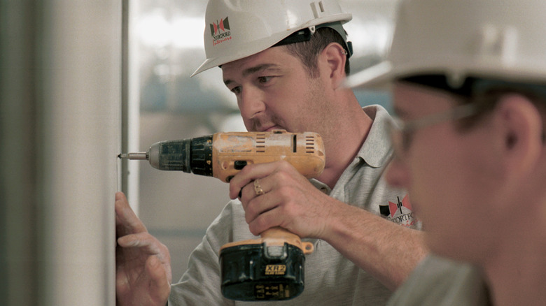 Person using a cordless drill