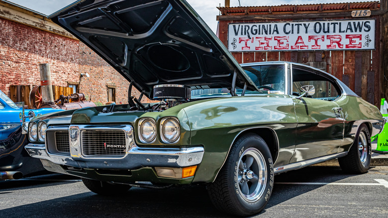 A green Pontiac LeMans at an auto show