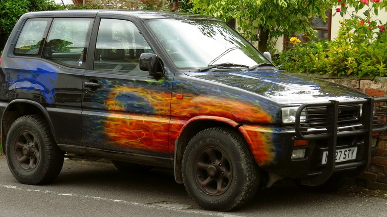 Black Ford Maverick SUV with flame decals