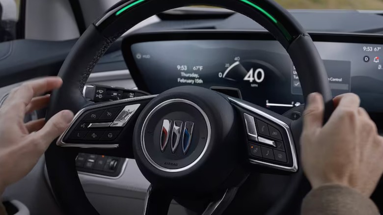 Person gripping Buick steering wheel