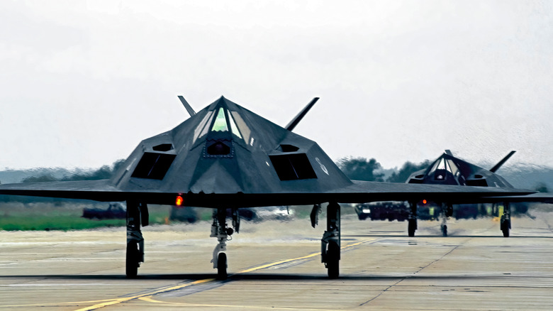 A pair of F-117 Nighthawks taxiing on a runway