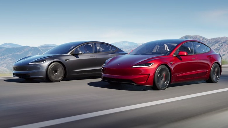 Two Tesla Model 3 cars driving side by side