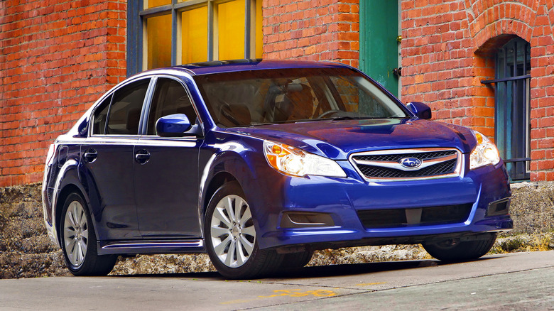 dark blue 2012 Subaru Legacy 3.6R parked in front of a brick building