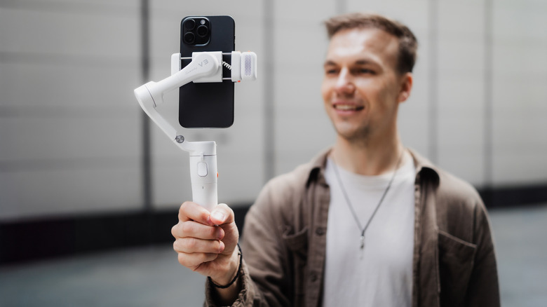 Man holding Hohem iSteady V3 Gimbal Stabilizer