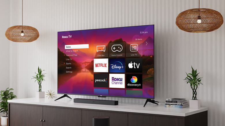 A Roku TV on the home screen sitting on the TV stand in the living room