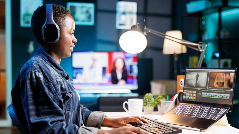 Woman editing video on laptop