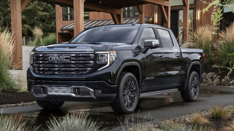 2022 GMC Sierra parked in front of a wood home