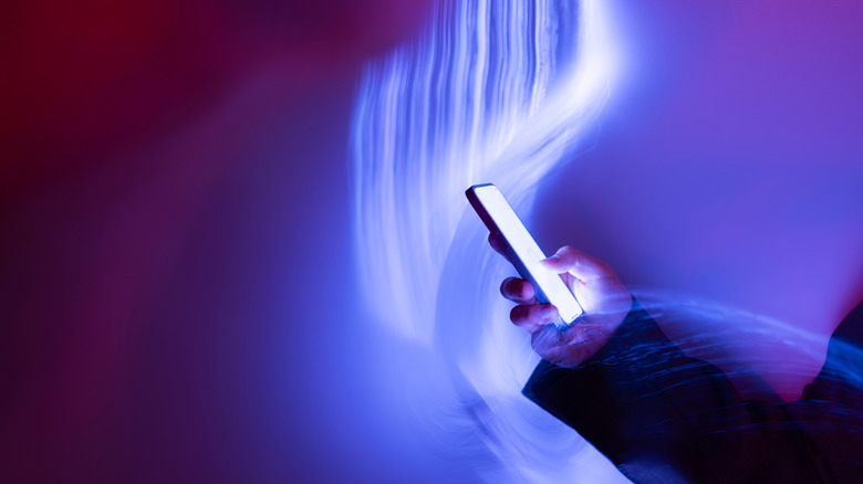 futuristic light concept surrounding phone in use