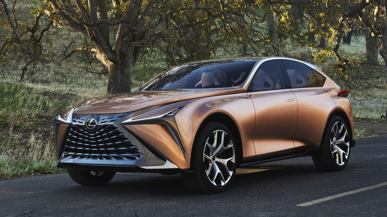 Lexus LF-1 Limitless concept crossover parked on a road with trees in the background, gront 3/4 view