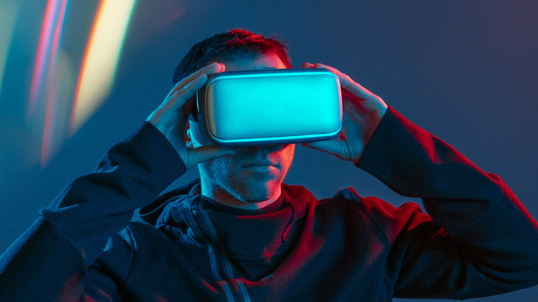 Man wearing a light blue virtual reality headset