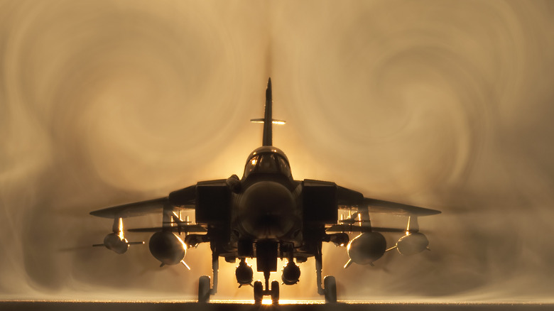 A fighter jet against a smoky backdrop