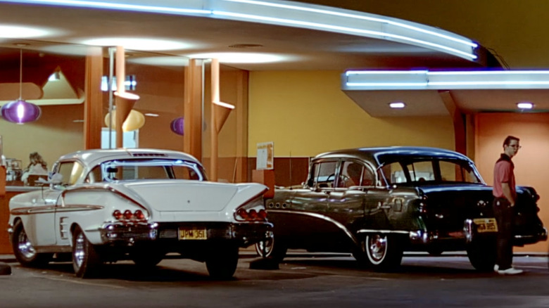 White Impala and black Chevy 150 parked outside Mel's Diner in American Graffiti