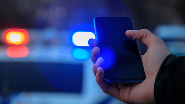 Smartphone with police car in background