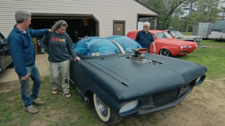 American Pickers hosts Mike Wolfe and Danielle Colby look over Rick Klibenski's Ultimus bubble car as Klibenski stands beside it