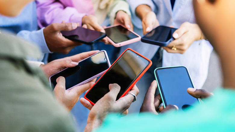 group of people holding phones