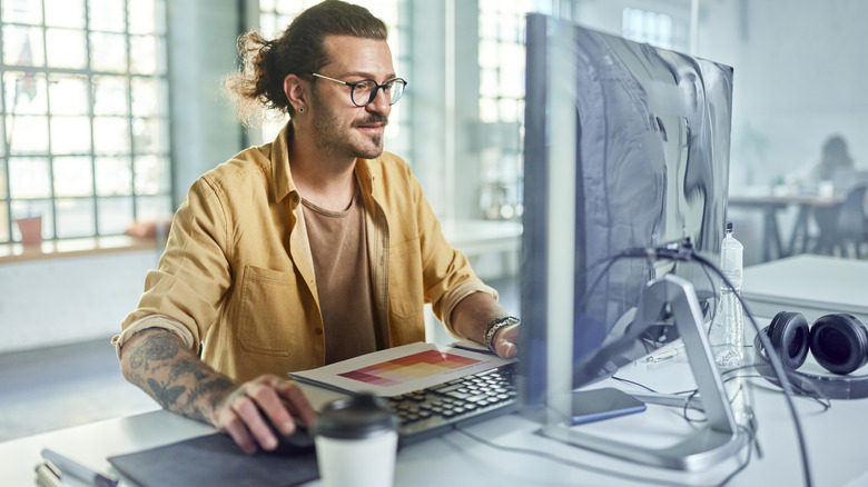 Person using fancy desktop PC in modern office