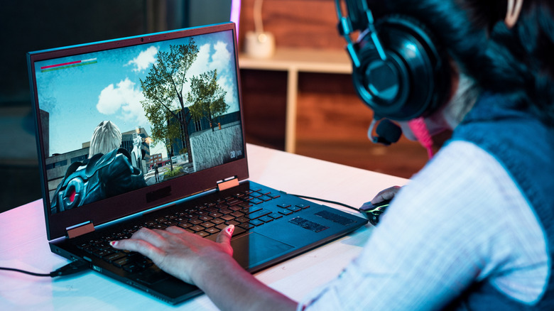 Woman gaming on a laptop