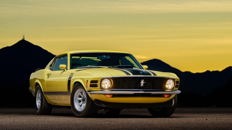 The Ford Mustang Boss 302 in yellow, front 3/4 view, sunset