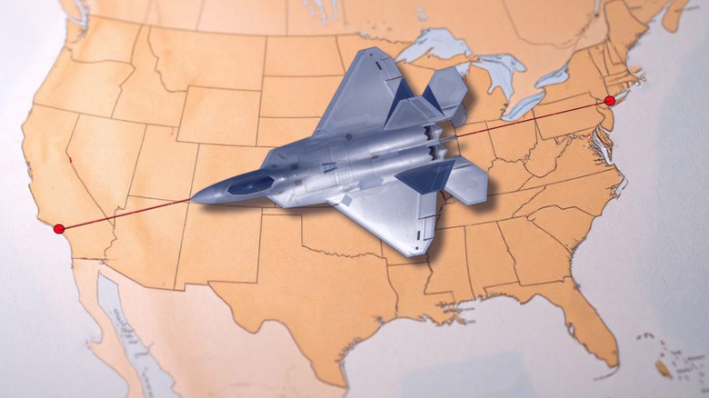 An F-22 Raptor flies across a digital map of the United States from New York to Los Angeles