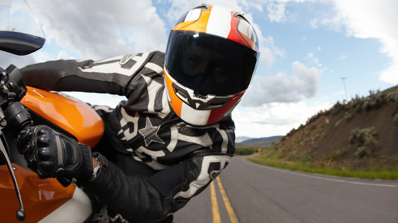 A man riding a motorcycle wearing a helmet