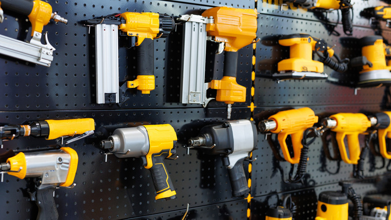 Various power tools hung up on a wall