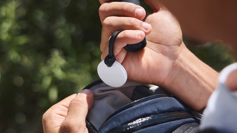 Chipolo Bluetooth tracker on a rope held in a hand