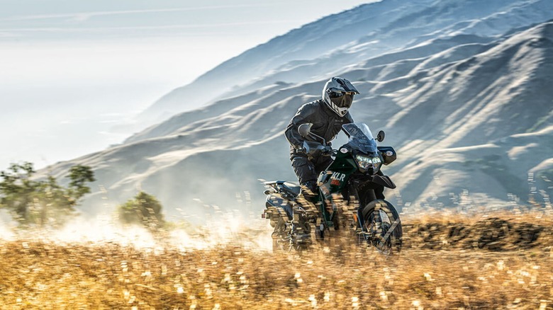 The Kawasaki KLR 650 riding on a dirt road.