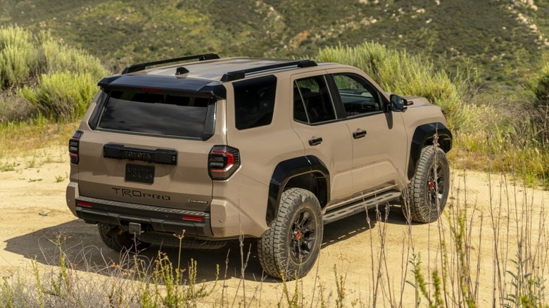 The 2025 Toyota 4Runner as seen from behind on dirt road