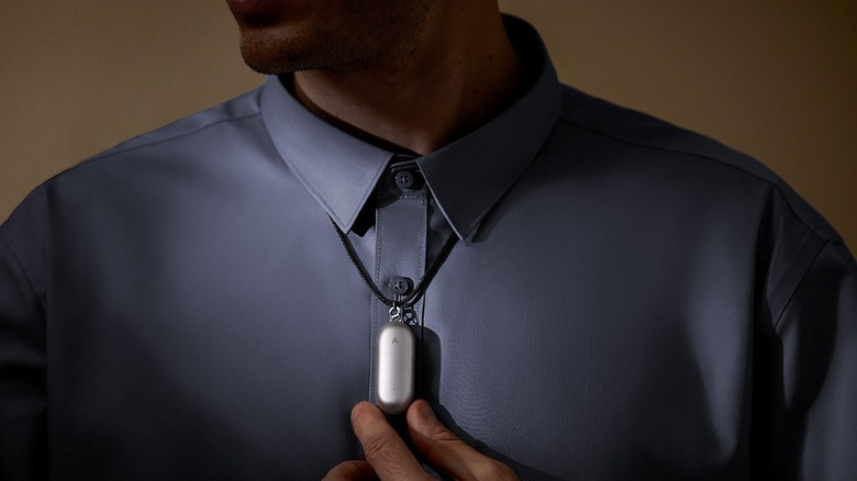 A person wearing the PLAUD NotePin as a pendant.